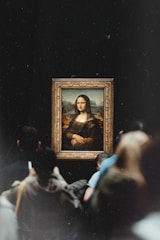 a group of people looking at a painting