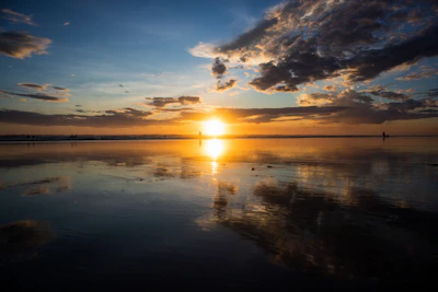 A stunning sunset over the calm turquoise waters of a secluded Brazilian beach