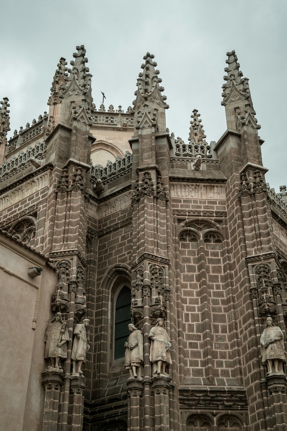 a very tall building with statues on it's sides