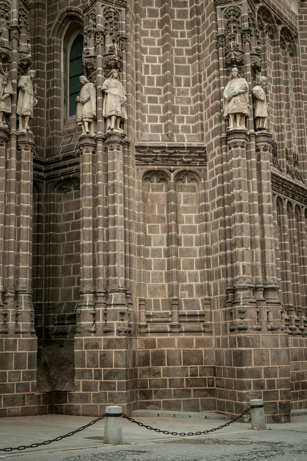 a large brick building with statues on the side of it