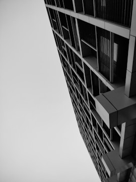 Black and white photo capturing the geometric patterns of a modern urban building facade.