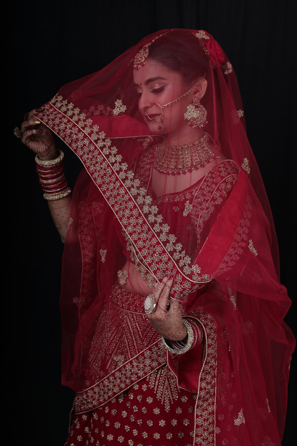 a woman in a red bridal outfit