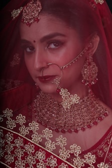 a woman in a red dress with a veil on her head