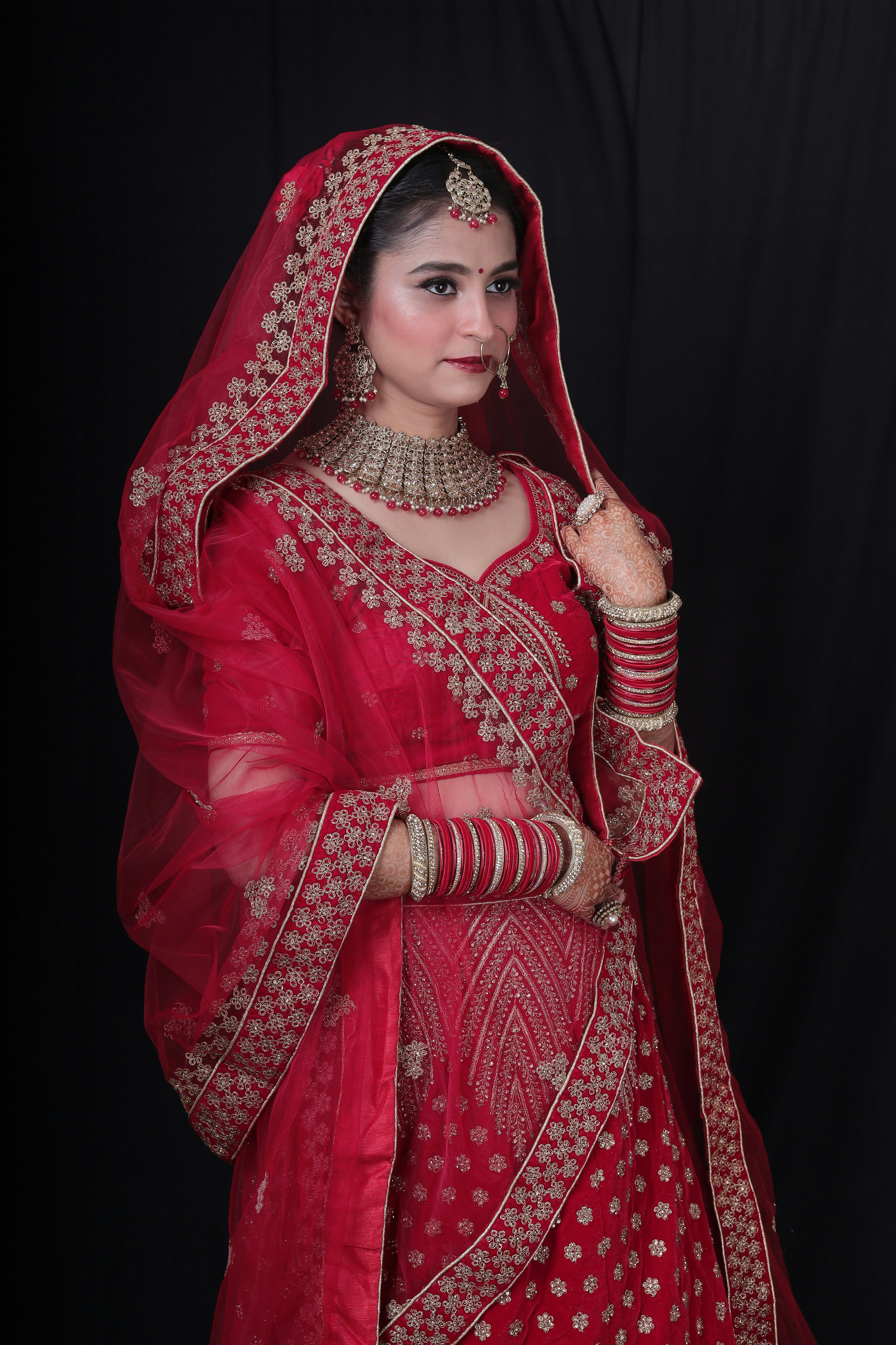 a woman in a red bridal outfit
