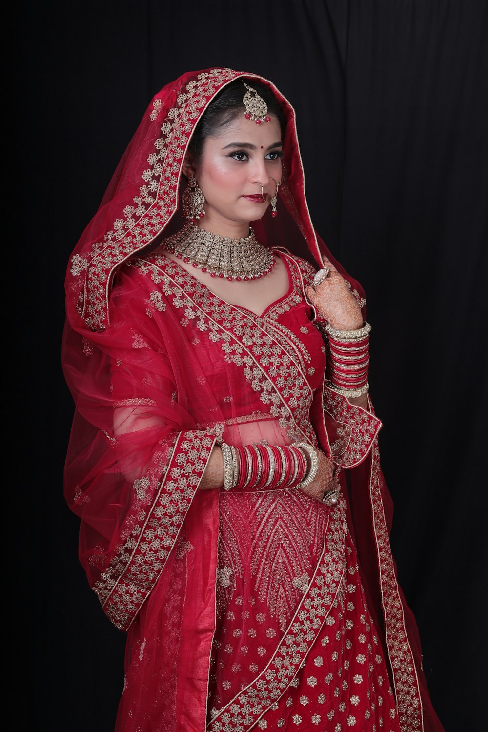 a woman in a red bridal outfit