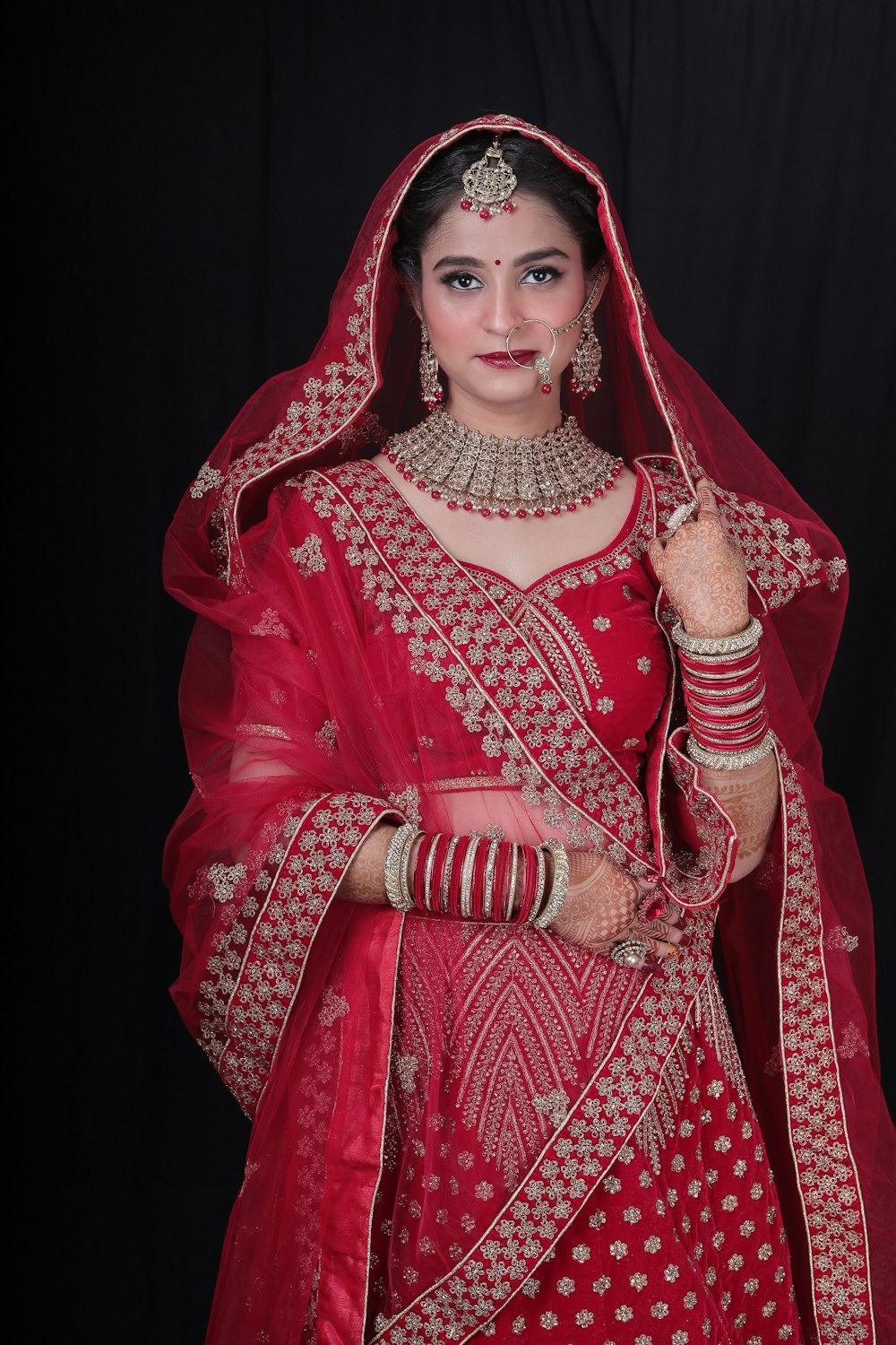 a woman in a red bridal outfit