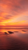 A serene beach sunset showcasing vibrant colors.