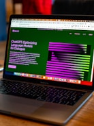 a laptop computer sitting on top of a wooden table