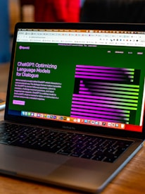 a laptop computer sitting on top of a wooden table