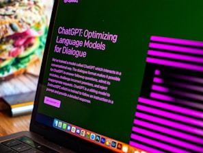 a laptop computer sitting on top of a wooden desk