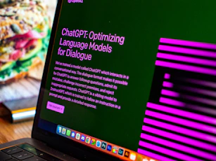 a laptop computer sitting on top of a wooden desk