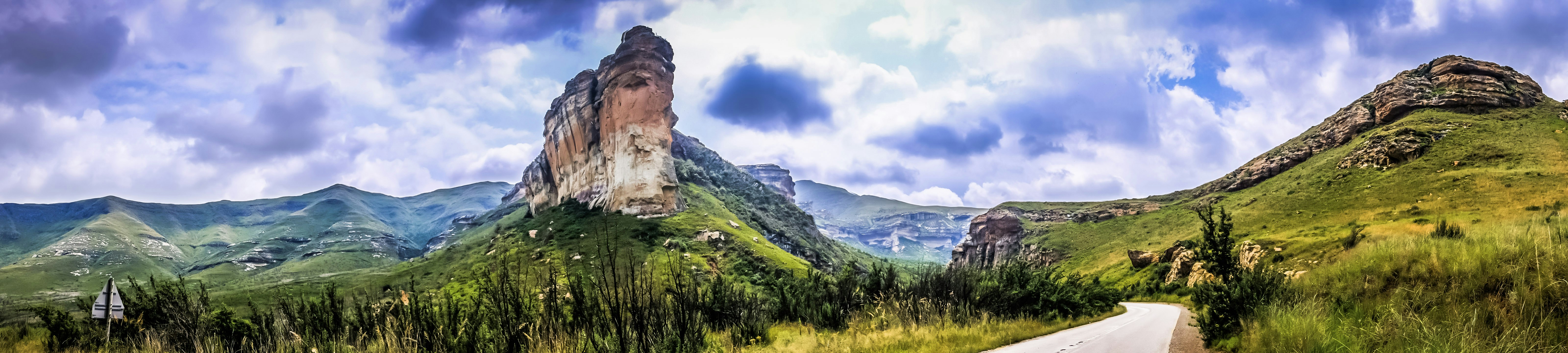 a scenic view of a mountain with a road going through it