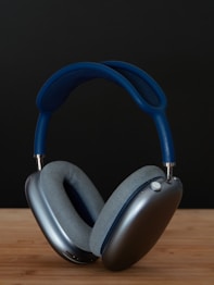 a pair of headphones sitting on top of a wooden table