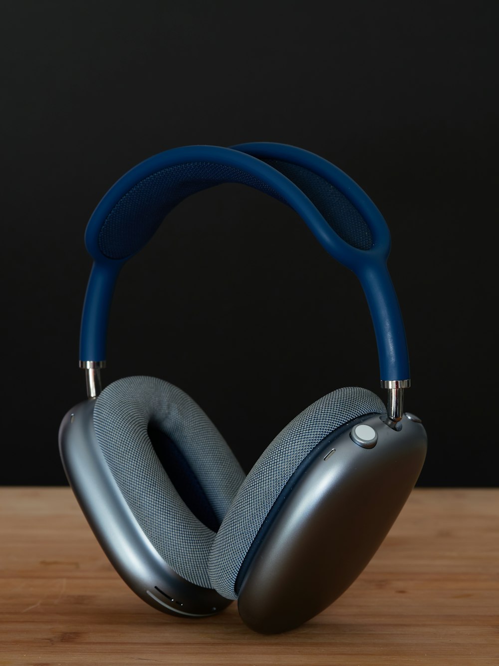 a pair of headphones sitting on top of a wooden table