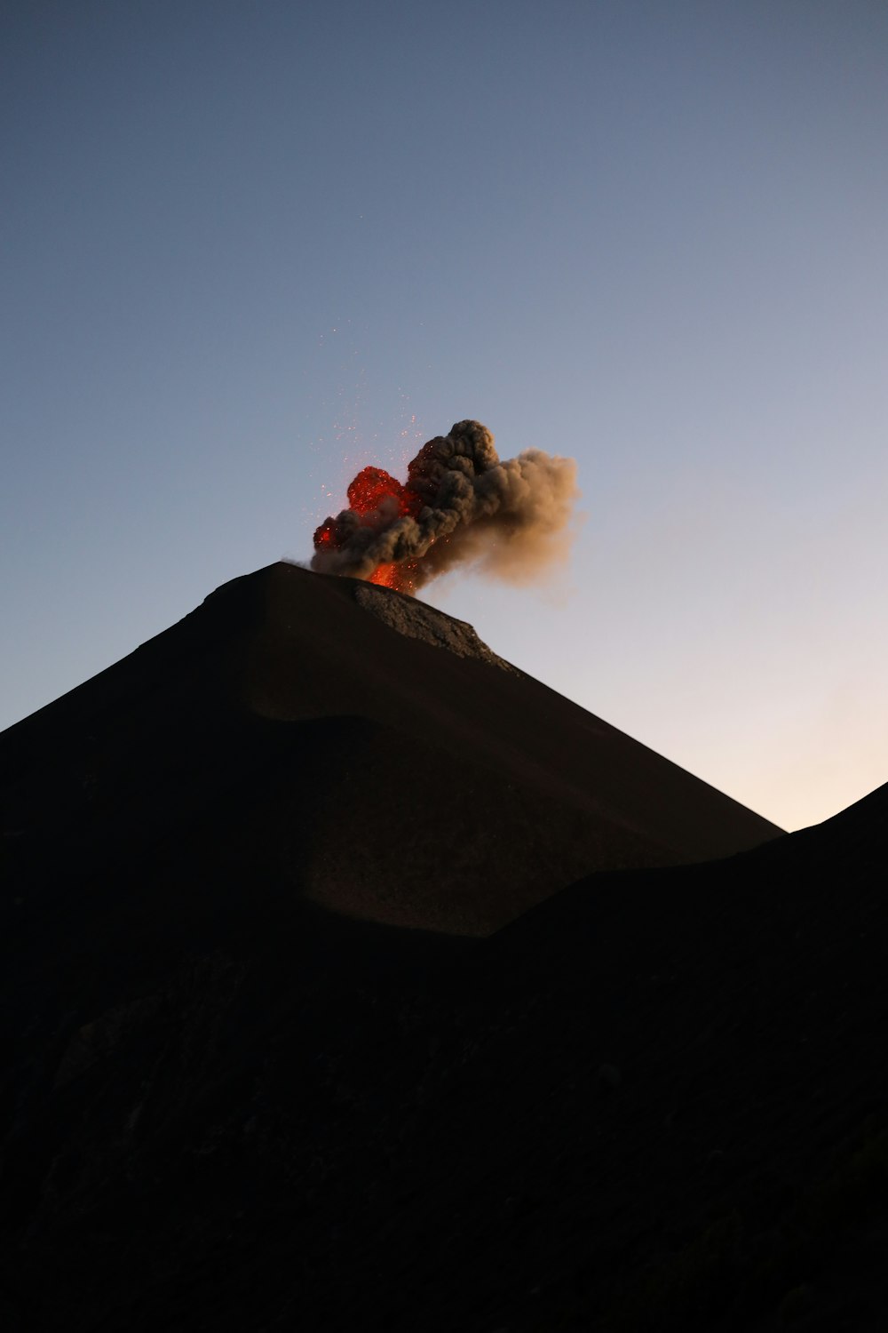 a large plume of smoke coming out of the top of a mountain
