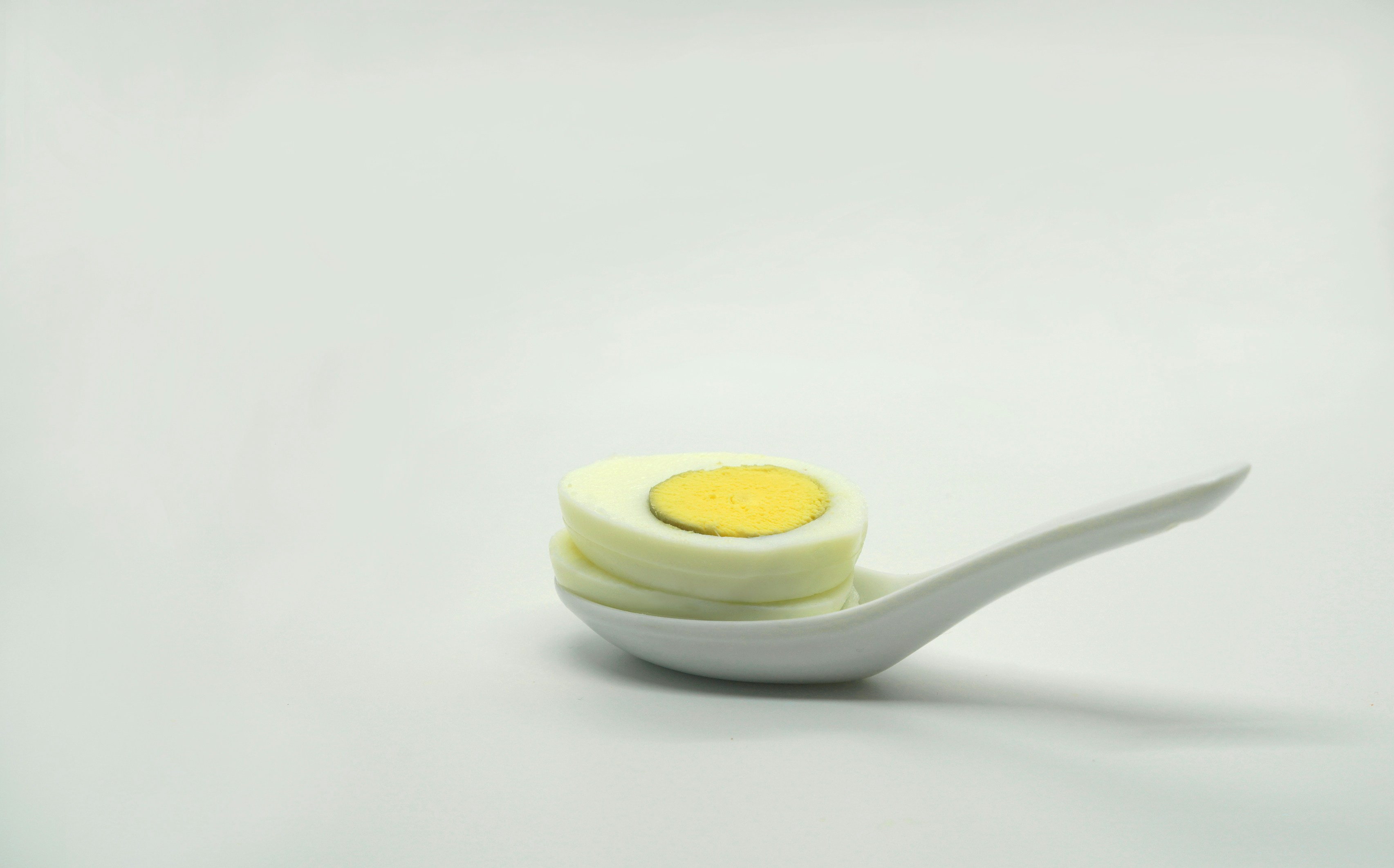 a white spoon with a yellow substance on it
