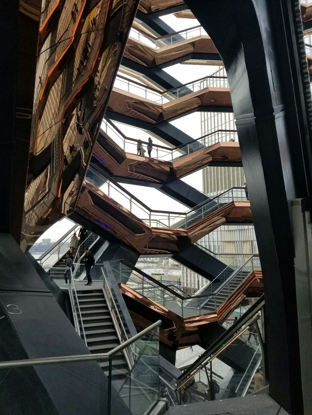 an escalator inside of a building with people walking up and down it