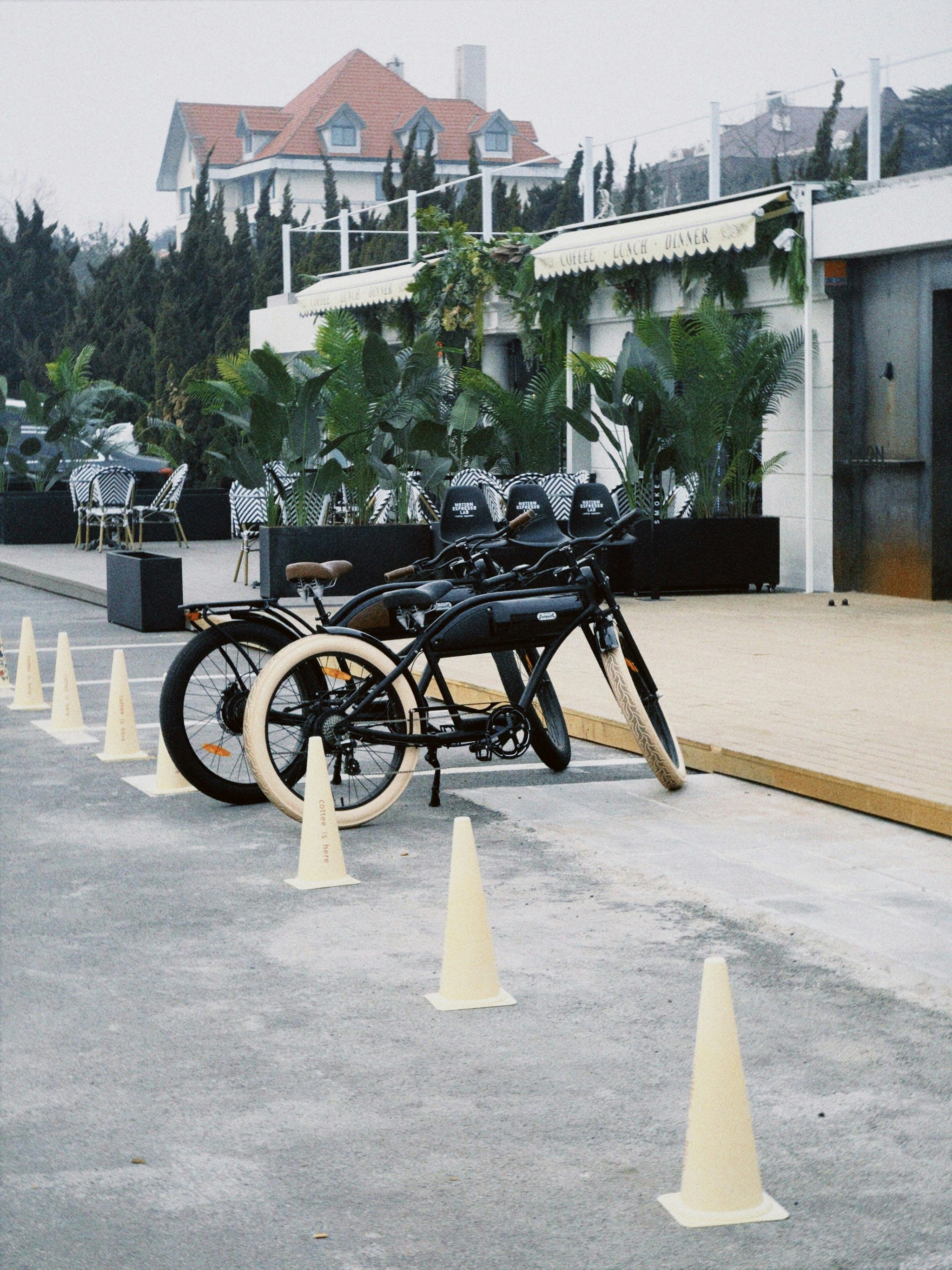 a row of motorcycles parked next to white cones