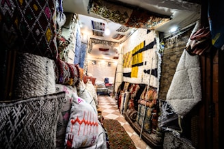 A cozy Moroccan riad corner with soft textiles and elegant women's outfits displayed.
