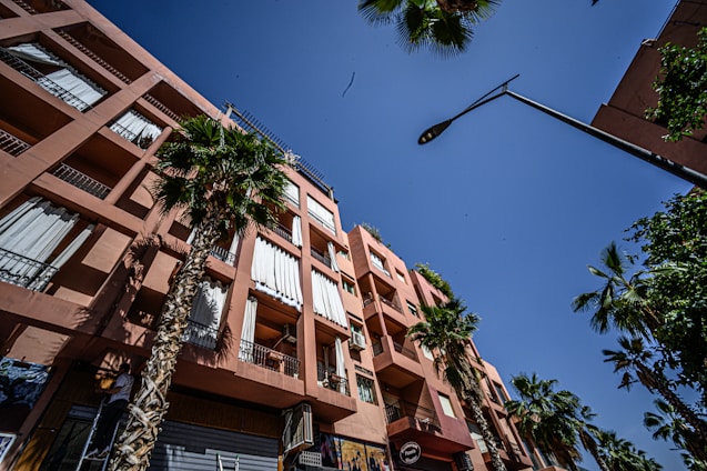 A friendly property manager discussing lease details with a happy tenant in a sunny California apartment.