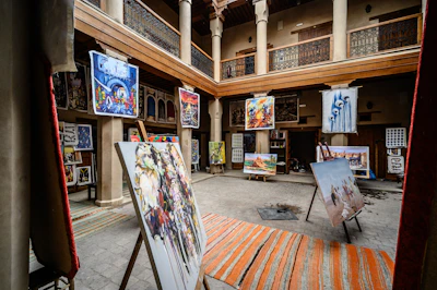A vibrant gallery space inside Musa with colorful Oaxacan paintings and sculptures displayed.