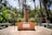 A beautifully designed garden featuring native plants and a tranquil seating area.