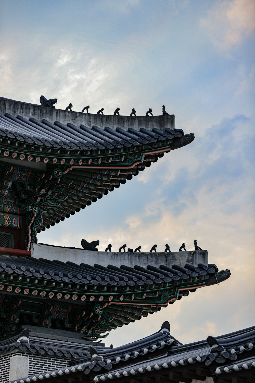 a group of birds sitting on the roof of a building