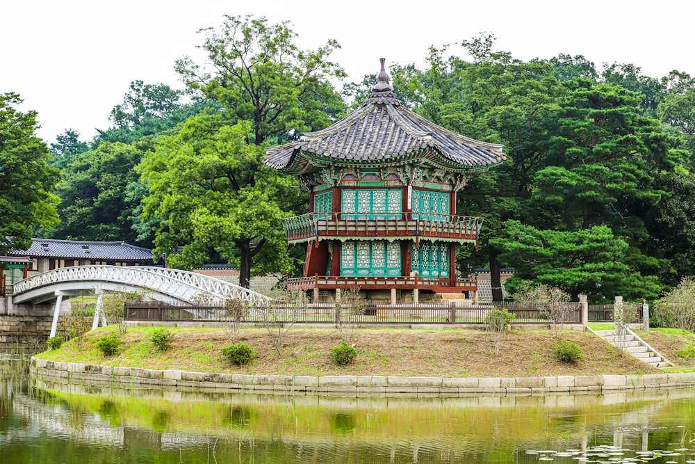 a small building sitting on top of a lush green field