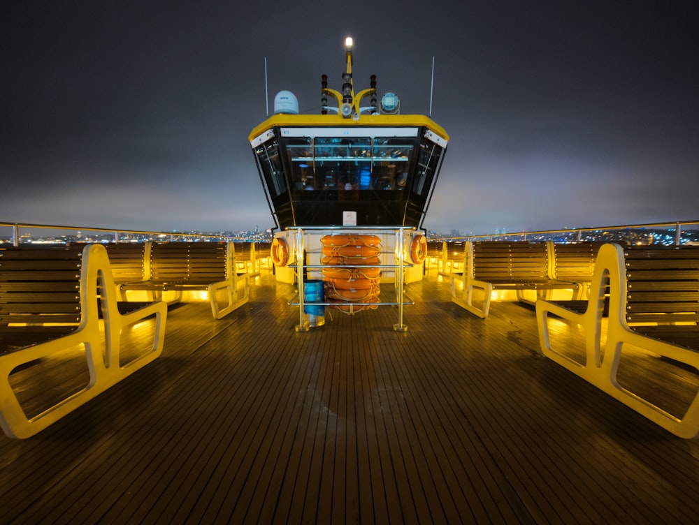 a yellow and black boat is docked at night