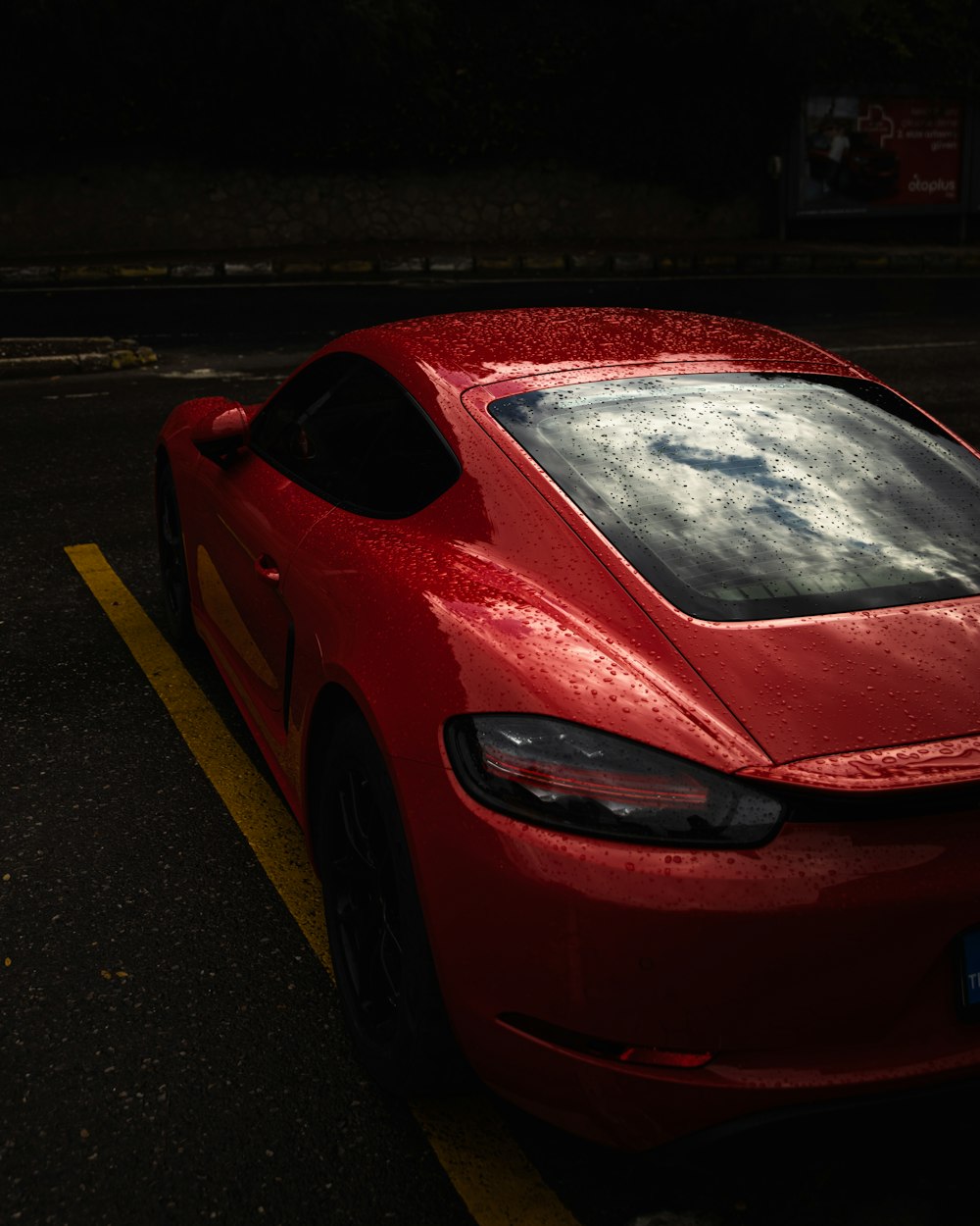 a red sports car parked in a parking lot
