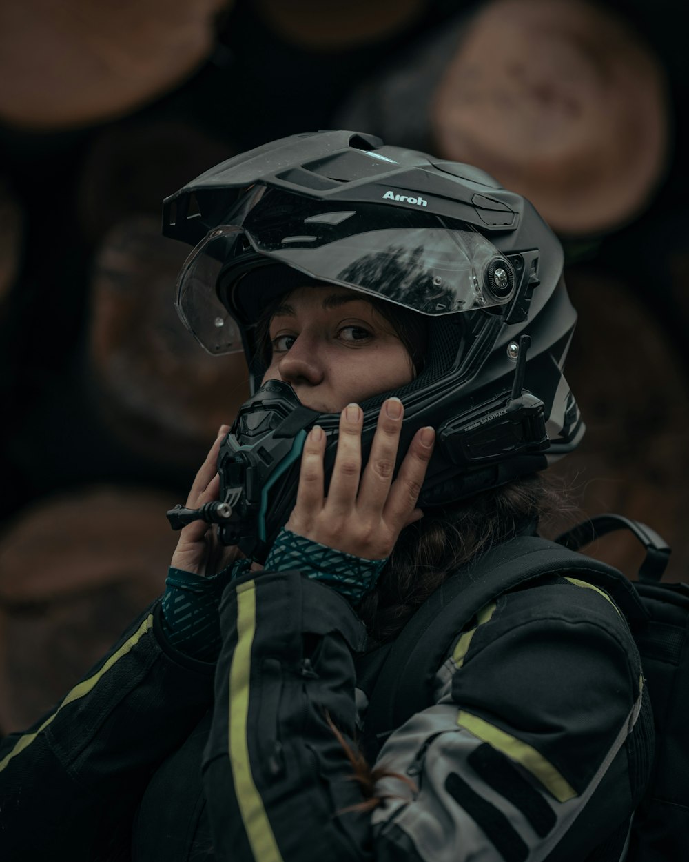 a woman wearing a helmet talking on a cell phone