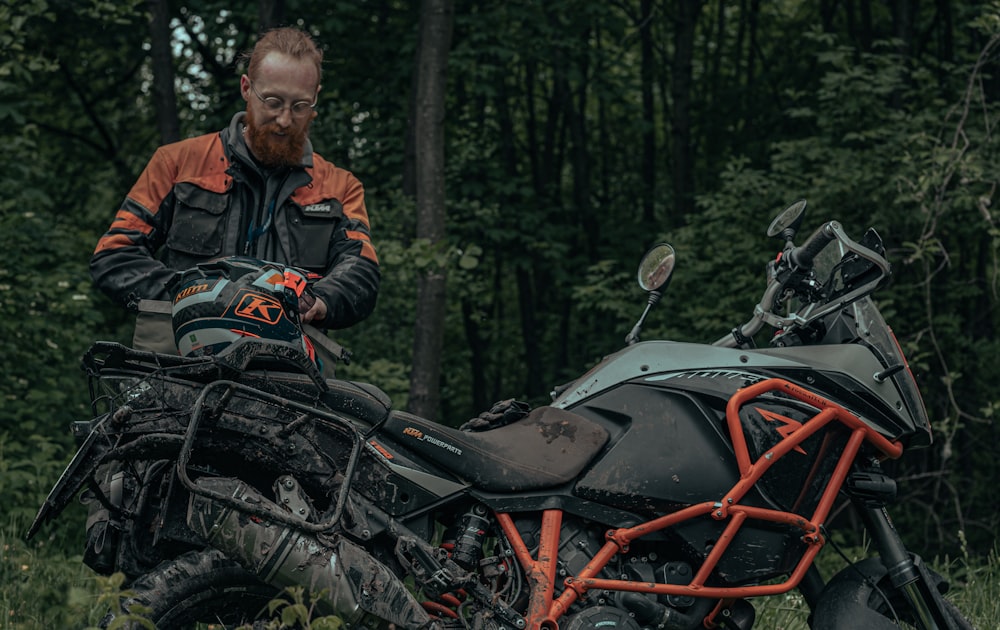 a man standing next to a parked motorcycle