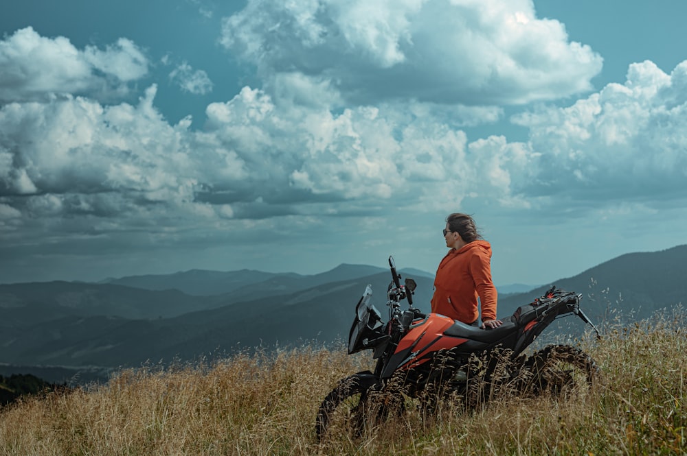 a person sitting on a motorcycle in a field