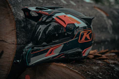 a helmet sitting on top of a tree stump