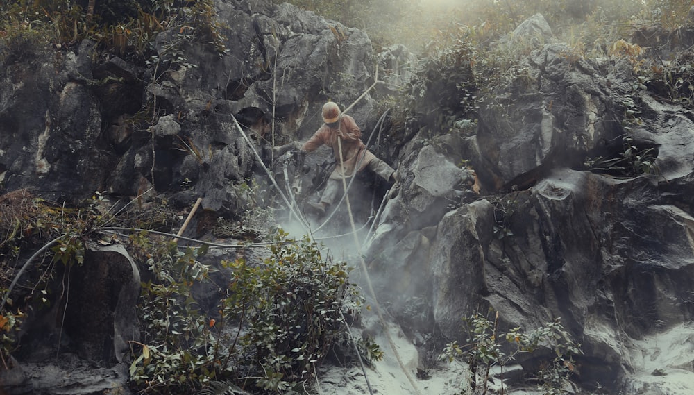 a painting of a man standing on a rock