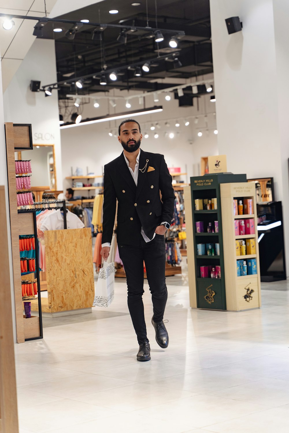 a man in a suit walks through a store