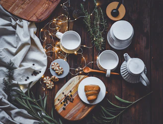 A cozy kitchen scene with freshly baked cupcakes and mini sandwiches arranged on a rustic wooden table.