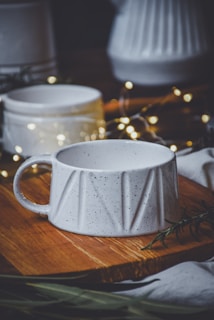 A cozy kitchen nook featuring white moose's minimalist ceramic mugs and wooden cutting boards bathed in soft morning light.