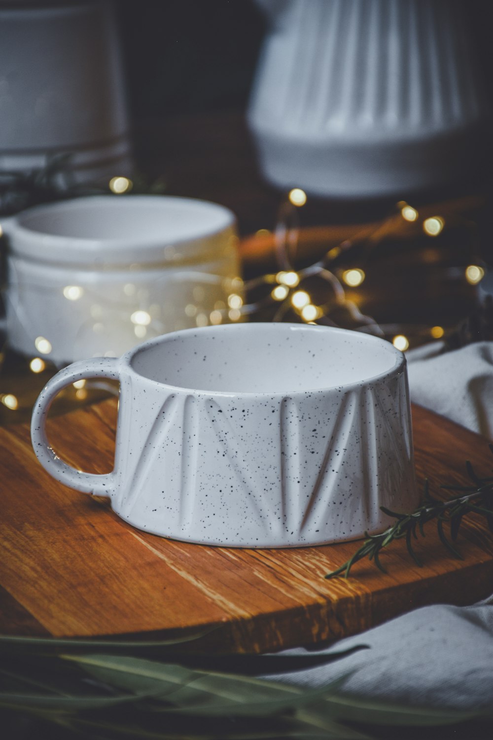 a white cup sitting on top of a wooden table