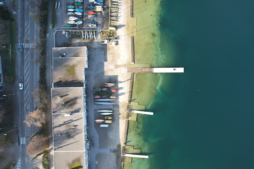 an aerial view of a parking lot next to a body of water