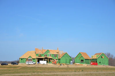 a green house under construction in the middle of a field