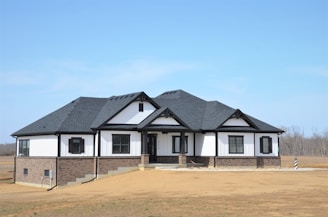a white and black house with a black roof