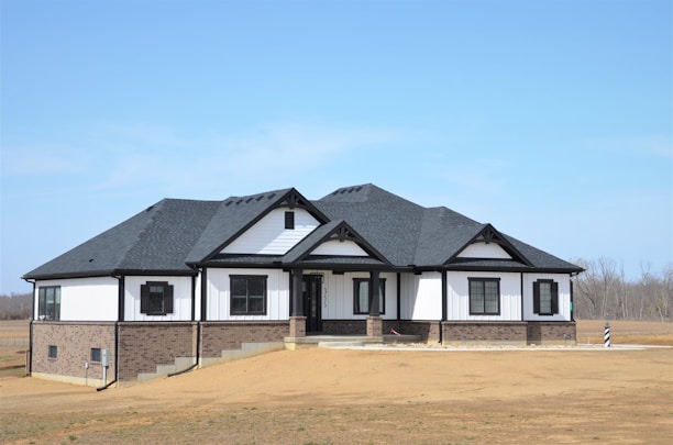 a white and black house with a black roof
