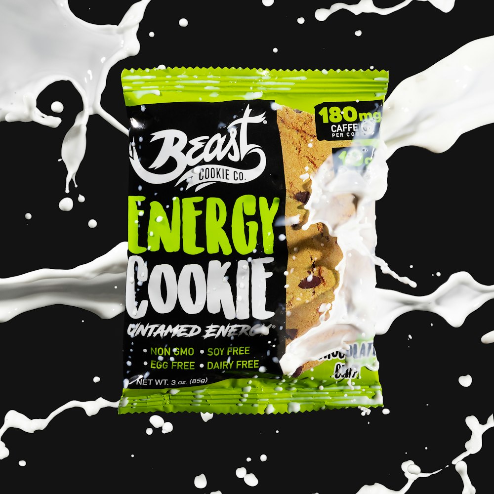 a bag of energy cookie next to a splash of milk