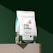 A bag of 1790 Coffee Specialty Coffee displayed on a green background. The coffee bag is white in the upper part with green at the bottom. It has labels indicating 'Signature Roast,' 'Single Origin Mexico,' 'Whole Bean,' and 'Medium Roast.' The design includes graphical elements of a building and a flame logo, along with text describing the flavors as 'Graham Cracker, Milk Chocolate, Orange.' The weight of the coffee is 12 oz (340g) and it is labeled as 100% Organic Arabica Coffee.