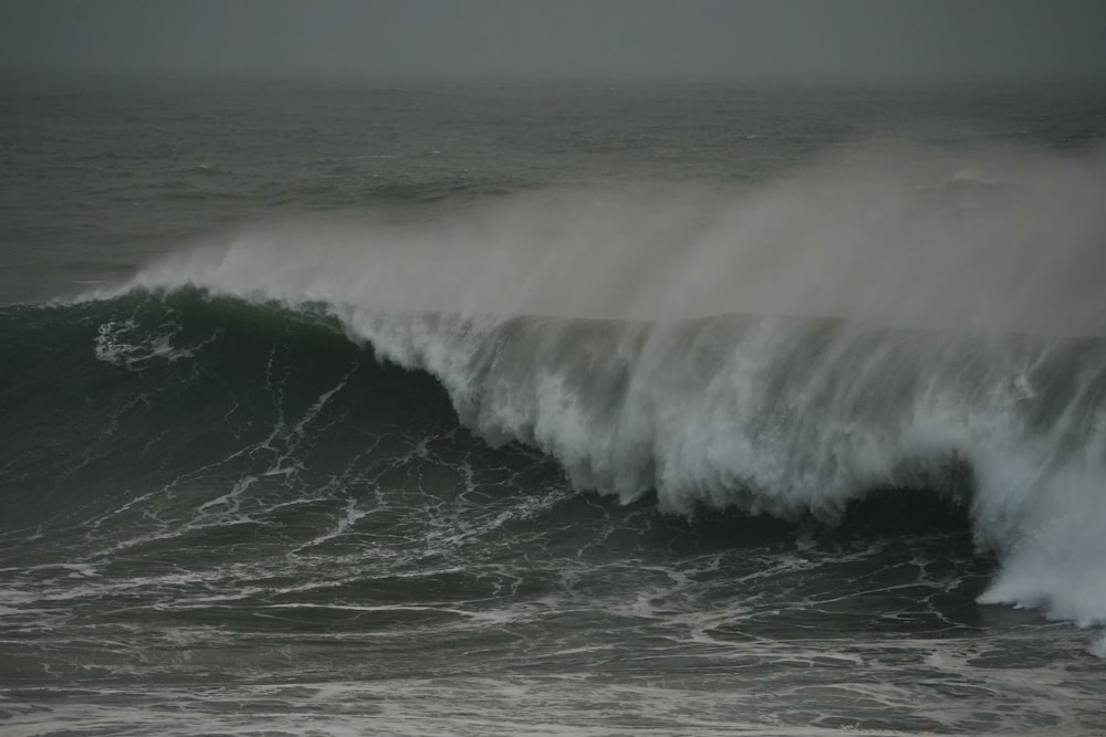 a large wave in the middle of the ocean