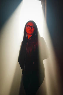 Cinematic portrait of an elite individual clad in lammoda’s bold leather outerwear, illuminated by soft bronze light.