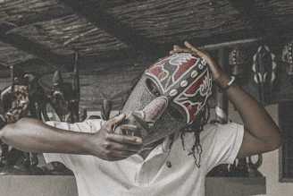 A vibrant traditional Lega mask displayed in a natural forest setting, symbolizing cultural heritage.