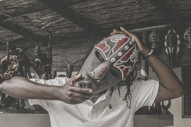 A vibrant traditional Lega mask displayed in a natural forest setting, symbolizing cultural heritage.