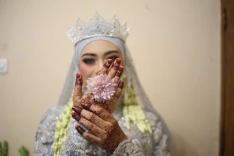 A professional wedding photographer capturing the bride's intricate mehndi details in Hisar.